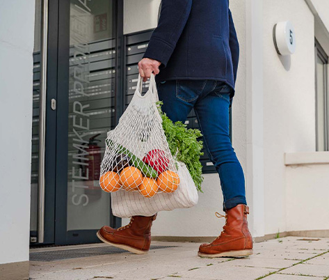 Ein Mann mit einer Obsttüte